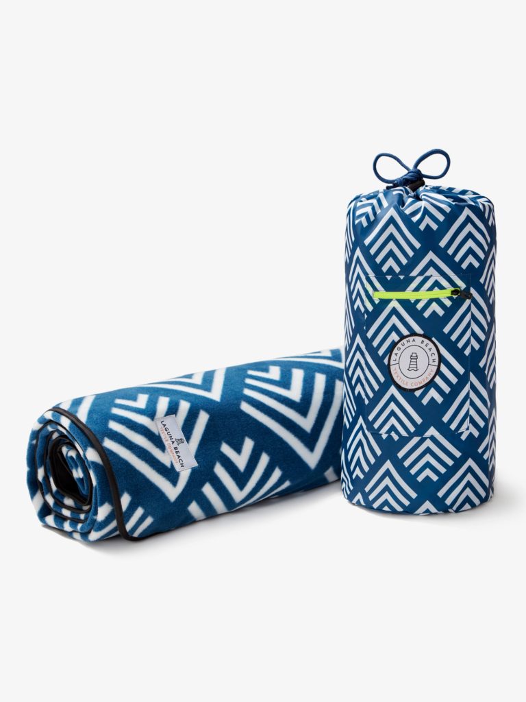 rolled up blue outdoor blanket with white detailing and a drawstring bag.