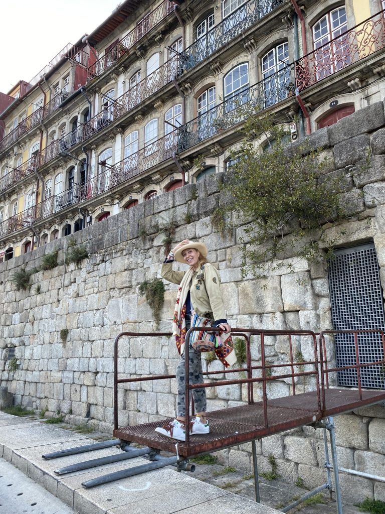 Stephanie von Watzdorf standing on a metal bridge in a city.